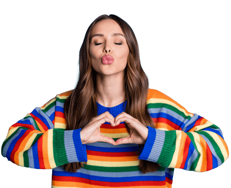 A confident young woman purses her lips in a kiss and makes a heart gesture with her hands.